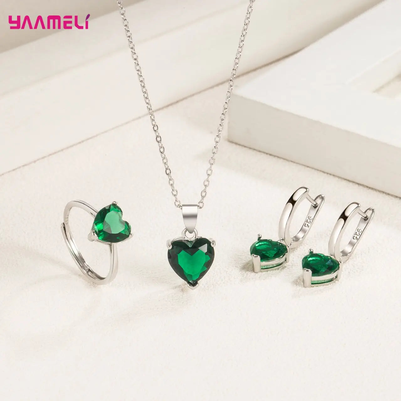Sterling silver heart-shaped pendant necklace featuring a vibrant green zircon gemstone centerpiece with a delicate chain from the zircon huggies jewelry set.