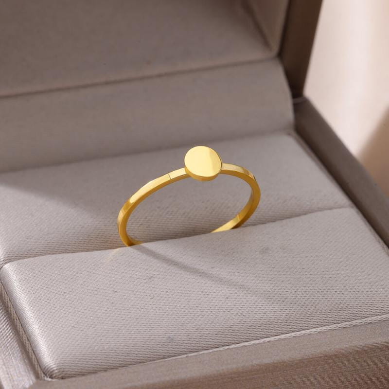 A minimalist stainless steel gold color ring for women featuring a smooth circular disc atop a slender band ideal for vintage wedding jewelry.