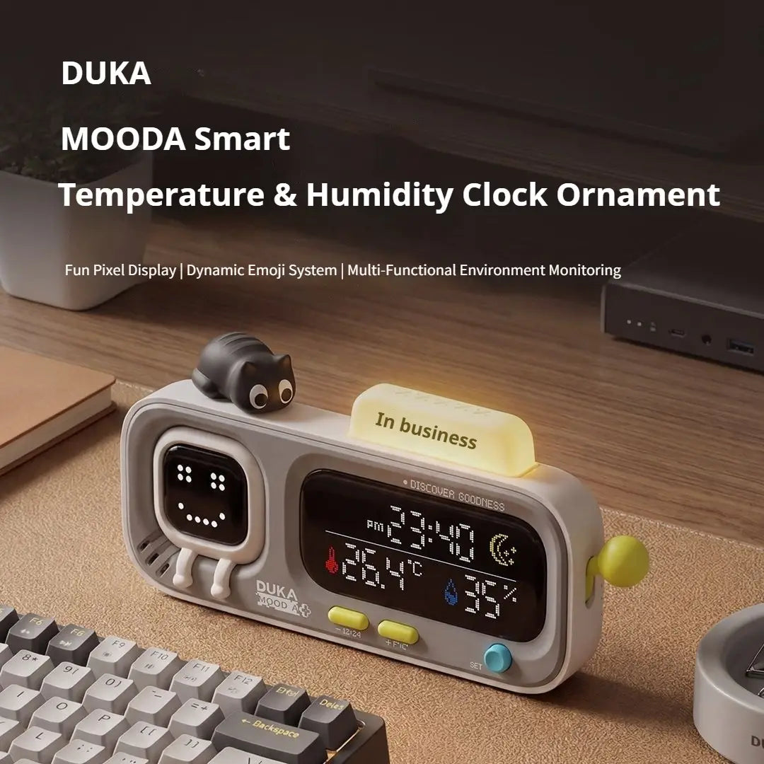 gray duka mooda smart temperature and humidity clock ornament featuring a cute black cat figurine on top and colorful buttons for easy use as a smart temperature monitoring device.