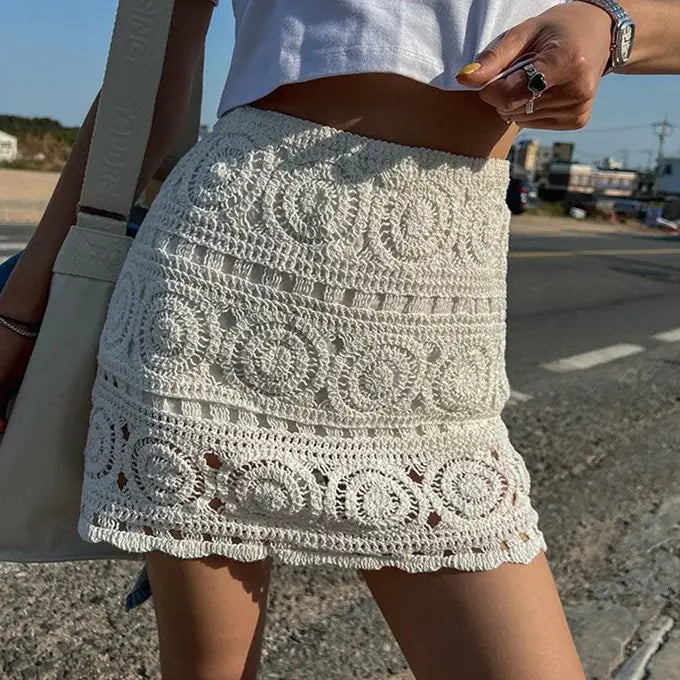 A white crochet mini skirt with intricate circular lace patterns and a fringed hem from the crochet lace maxi skirt off-white summer long skirt collection.