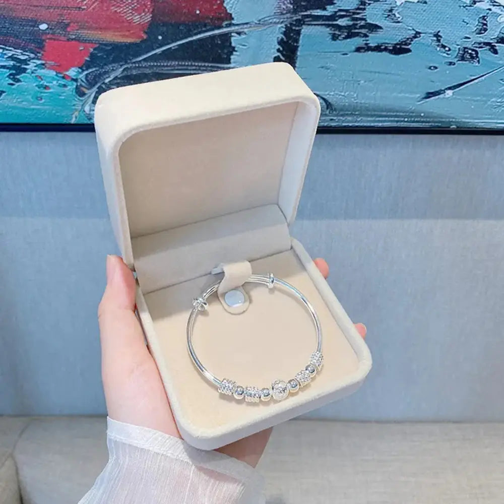 Sterling silver exquisite beaded bangle bracelet for women with clear crystal beads and a magnetic clasp displayed in an elegant cream-colored velvet box ideal as a party gift.