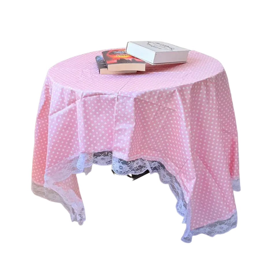 Pink polka dot lace trim tablecloth with white lace edging shown from a top-down view