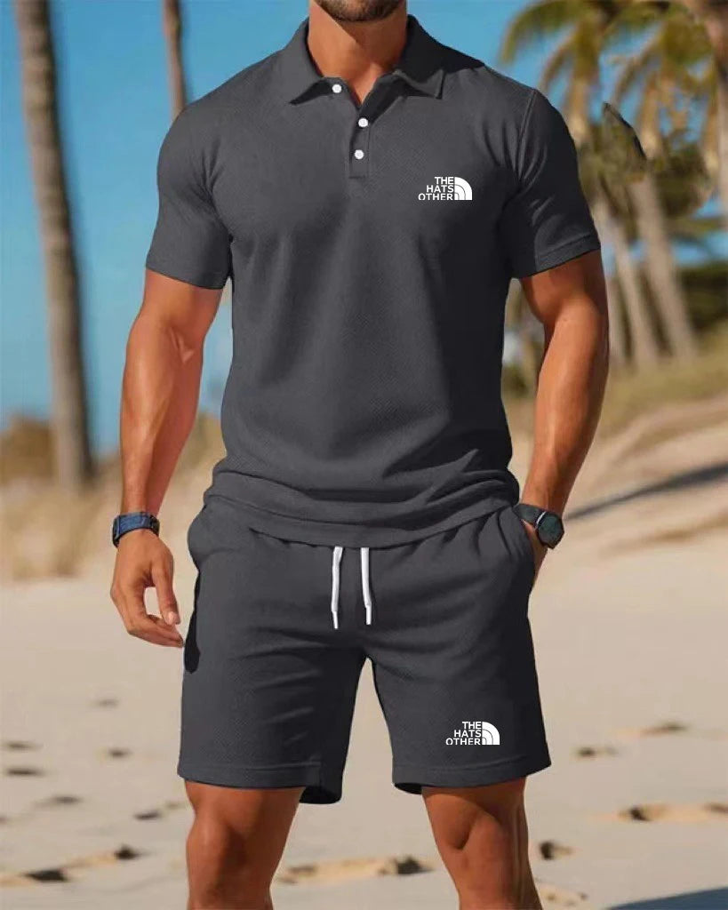 Men’s knit polo shirt and shorts set featuring a dark gray The North Face polo shirt with white button accents and a small logo on the chest.