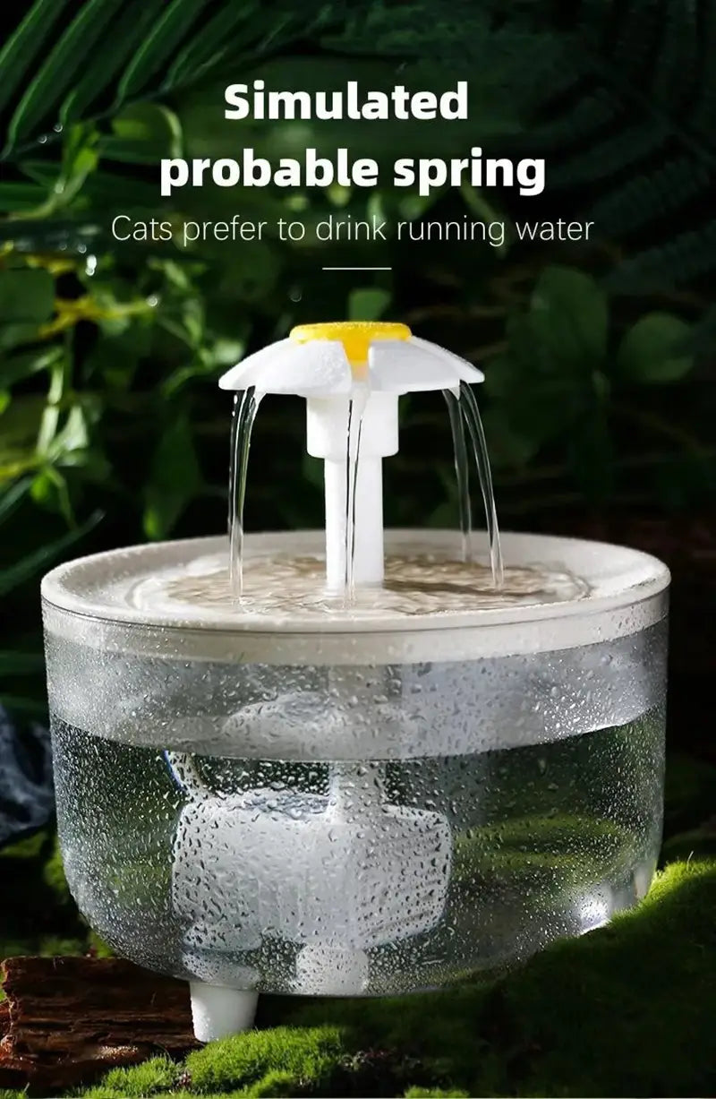 Clear plastic cat water fountain with a white and yellow flower-shaped spout designed as a daisy flower usb pet water dispenser simulating running spring water.