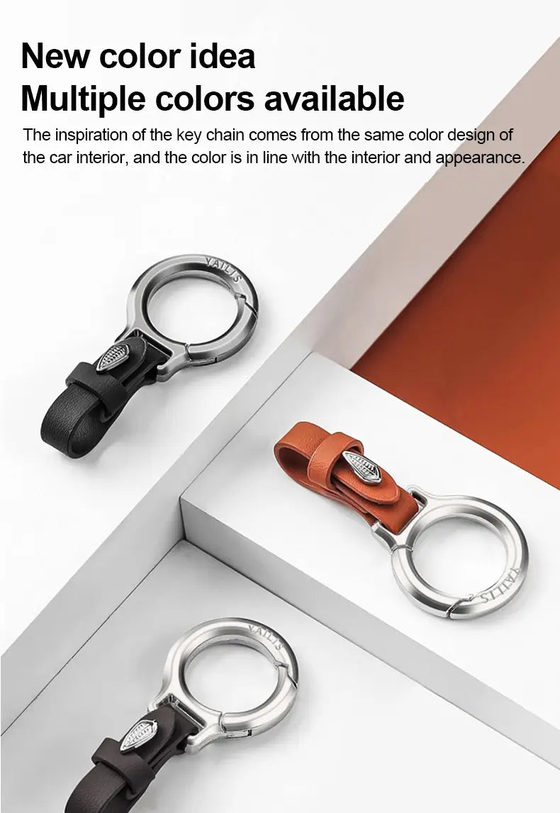 Lederschlüsselanhänger für den Pkw in silberner Metalloptik, mehrzweckiger Anti-Verlust-Halter, mit schwarzen und braunen Lederriemen sowie einem eleganten kreisförmigen Ringdesign.