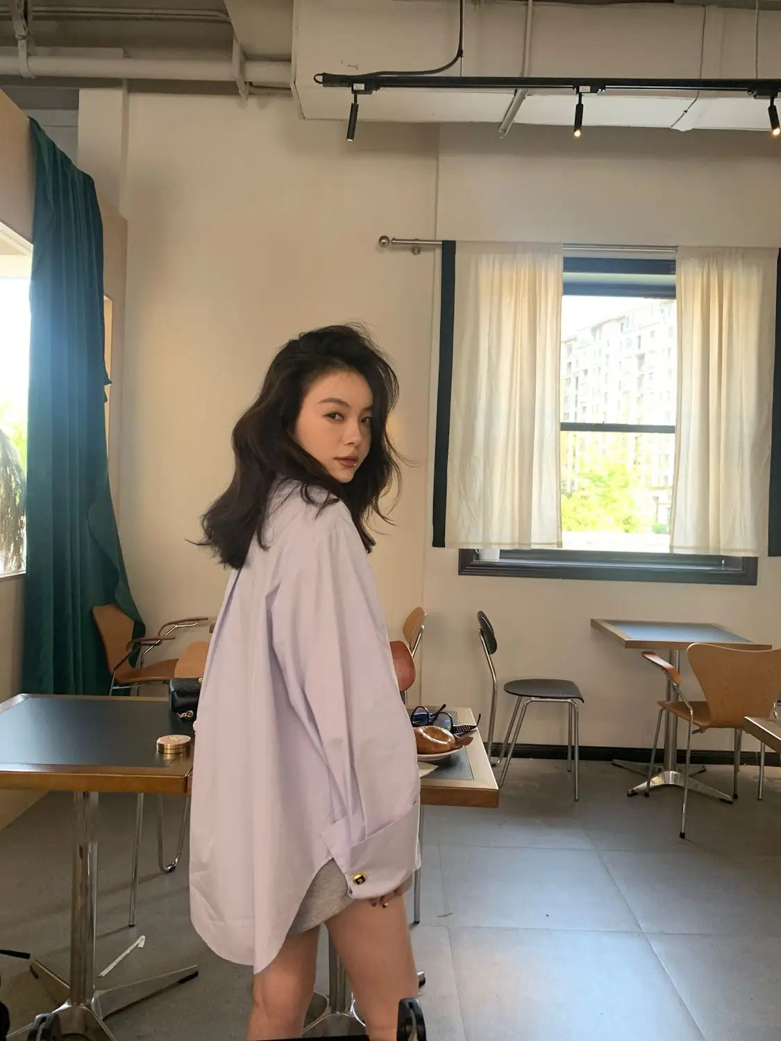 Light blue oversized button up shirt in pale lavender with a loose fit relaxed silhouette and subtle button details.