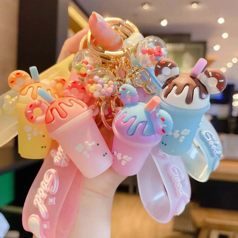 A collection of colorful pastel silicone ice cream keychains with chocolate and rainbow sprinkles made of personalized PVC hanger material.