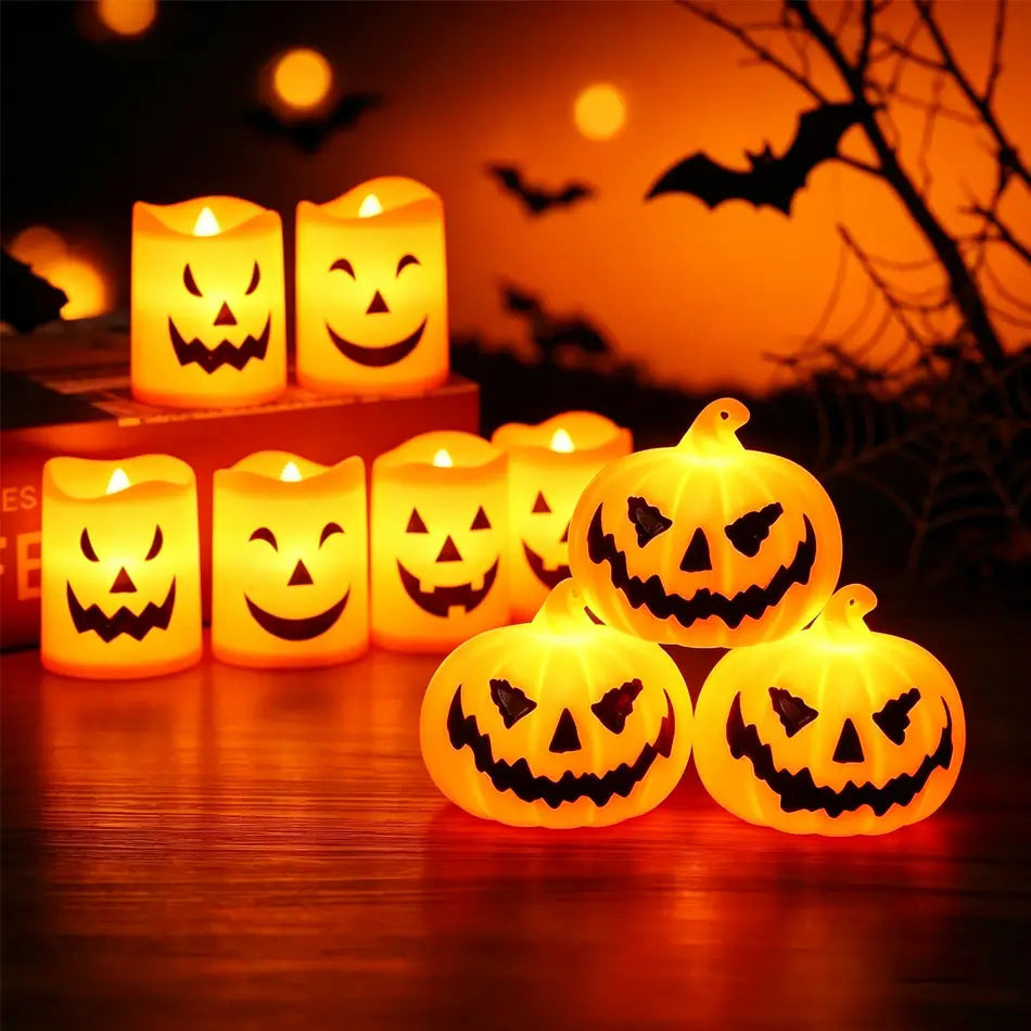 Orange LED Halloween pumpkin candles with black carved faces in a 6-pack set for festive seasonal decoration.