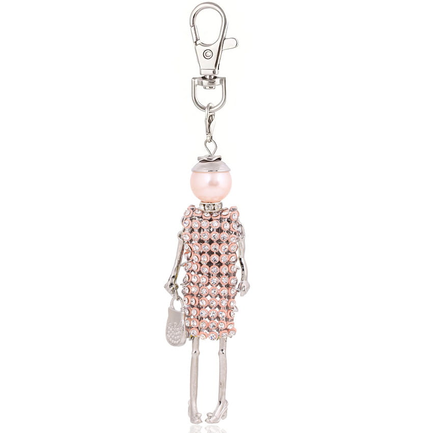 a delicate pink rhinestone doll keychain with a pearl head and silver skeleton limbs holding a tiny handbag as a women bag pendant