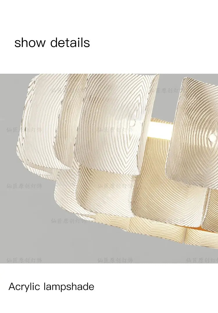 The minimalist wabi sabi led chandelier pendant light features an acrylic lampshade with a modern layered design of concentric ridges and a translucent white finish.