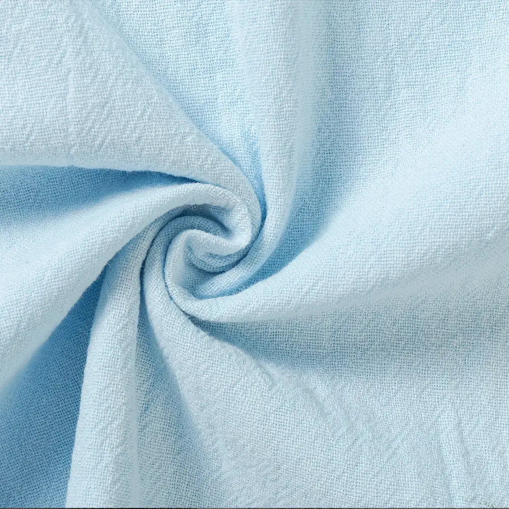 Men cotton linen trousers in light blue textured cotton fabric featuring a subtle woven pattern designed for breathable casual wear.