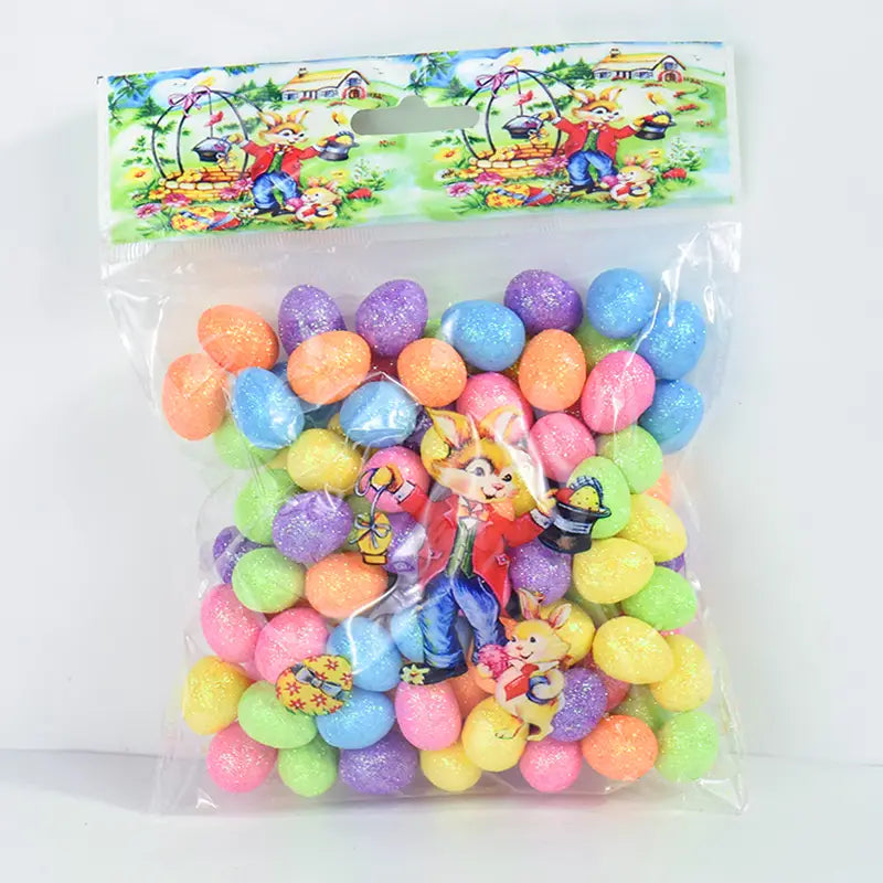A colorful assortment of glittery plastic foam Easter eggs in pastel shades packaged with a cartoon bunny-themed header for DIY party decor.