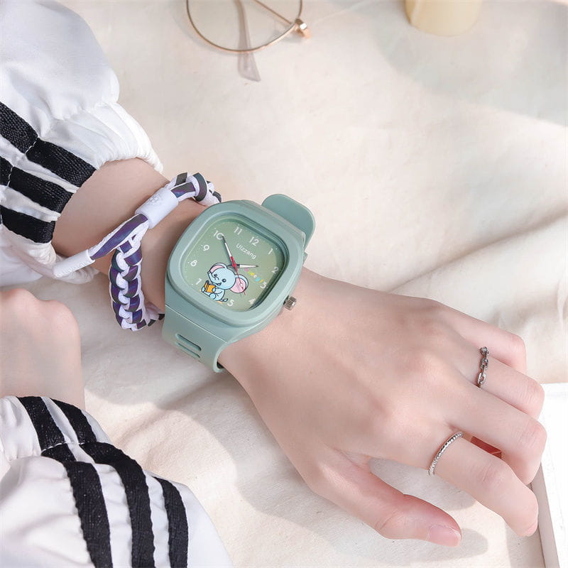 Mint green square-faced children’s watch with a luminous cartoon elephant design on the dial for kids.