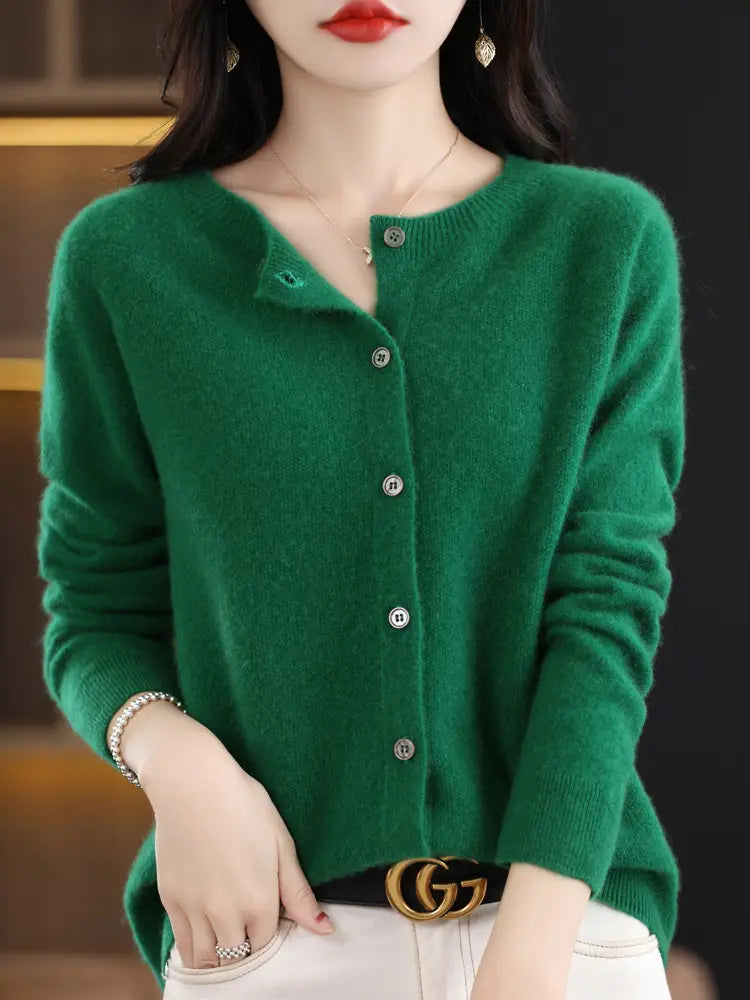 A soft emerald green merino wool cardigan for women featuring a round neckline and silver-toned buttons.