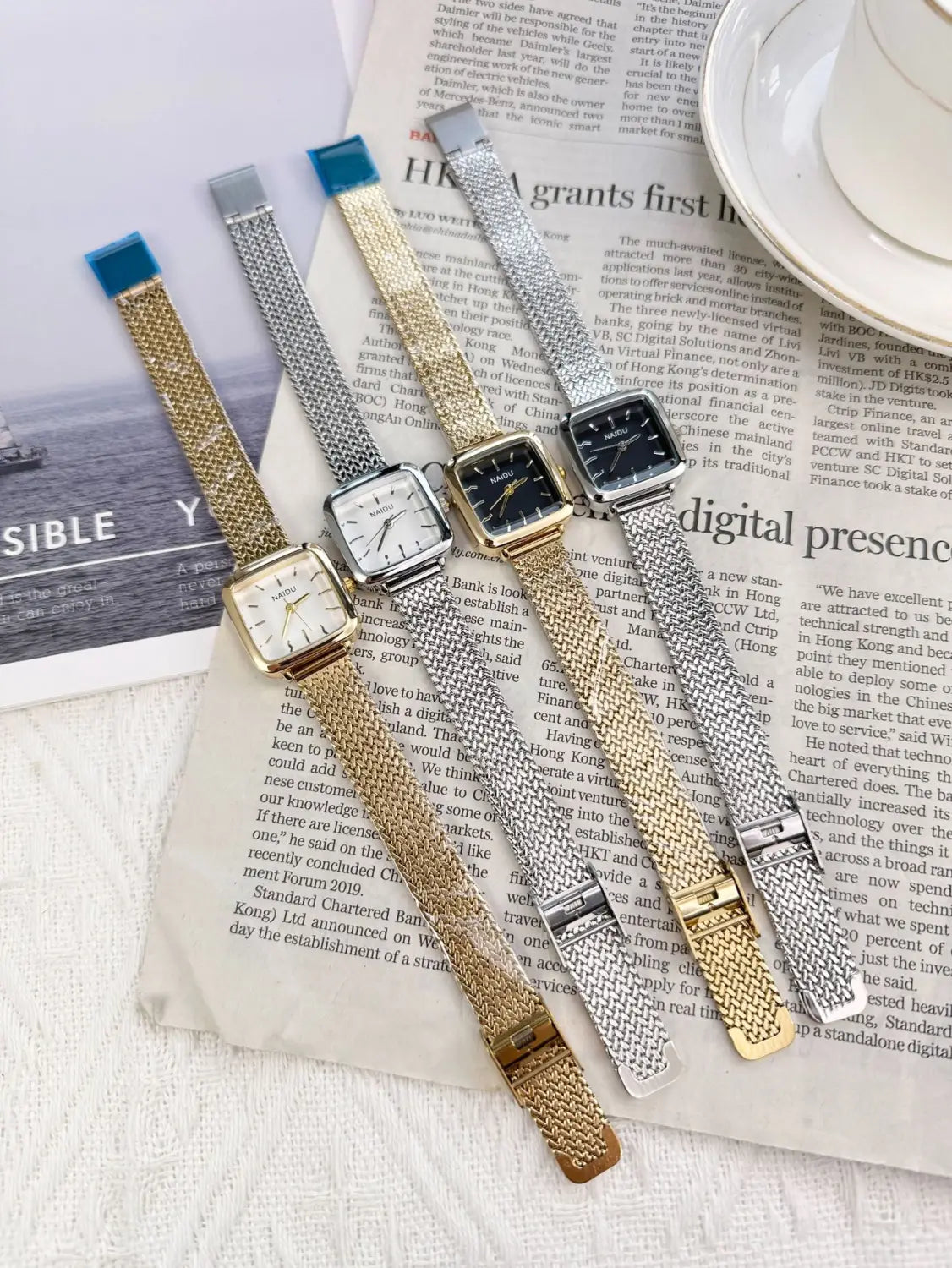 Three elegant minimalist square quartz watches for women with gold-tone mesh bands featuring white and black analog dials.