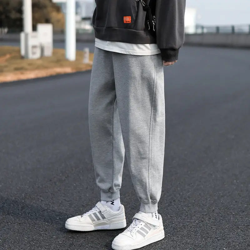 Men cargo pants multi pocket casual joggers in gray with soft textured fabric and elastic cuffs.