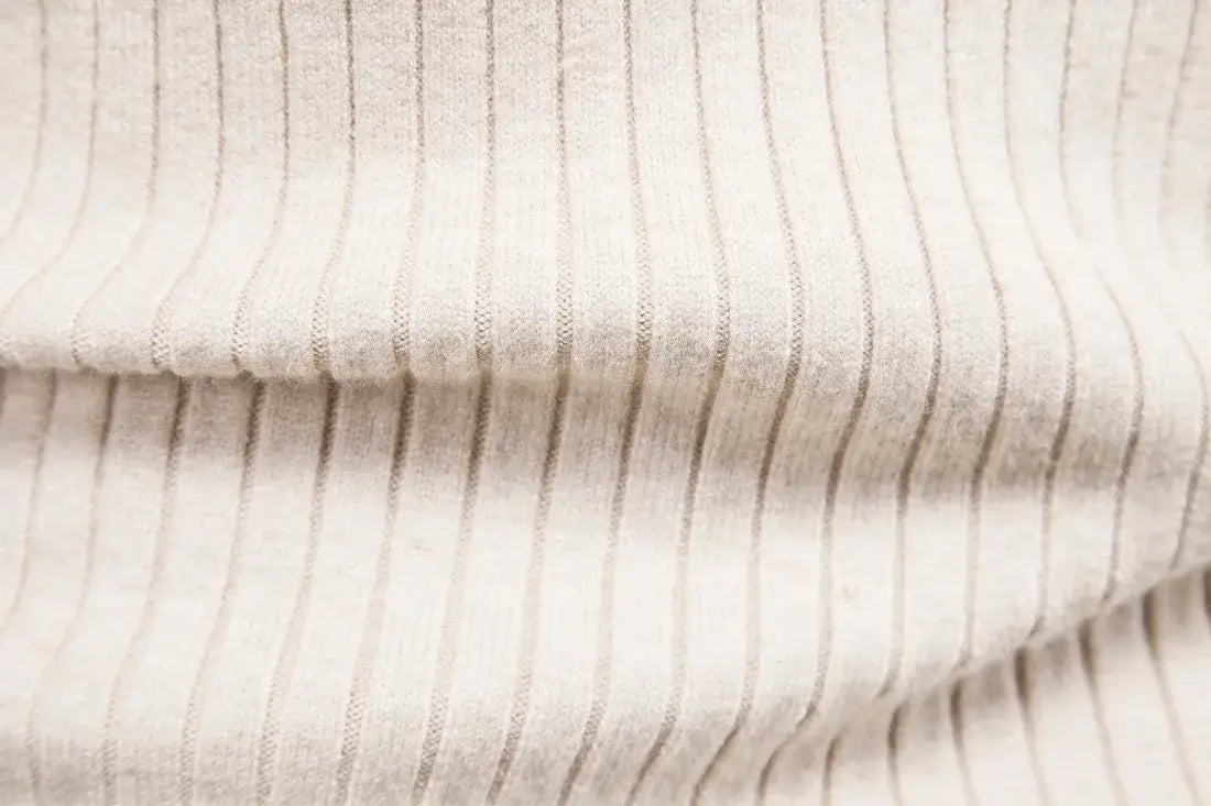 Men’s cable knit turtleneck pullover sweater made of beige ribbed fabric with subtle gray vertical stripes.