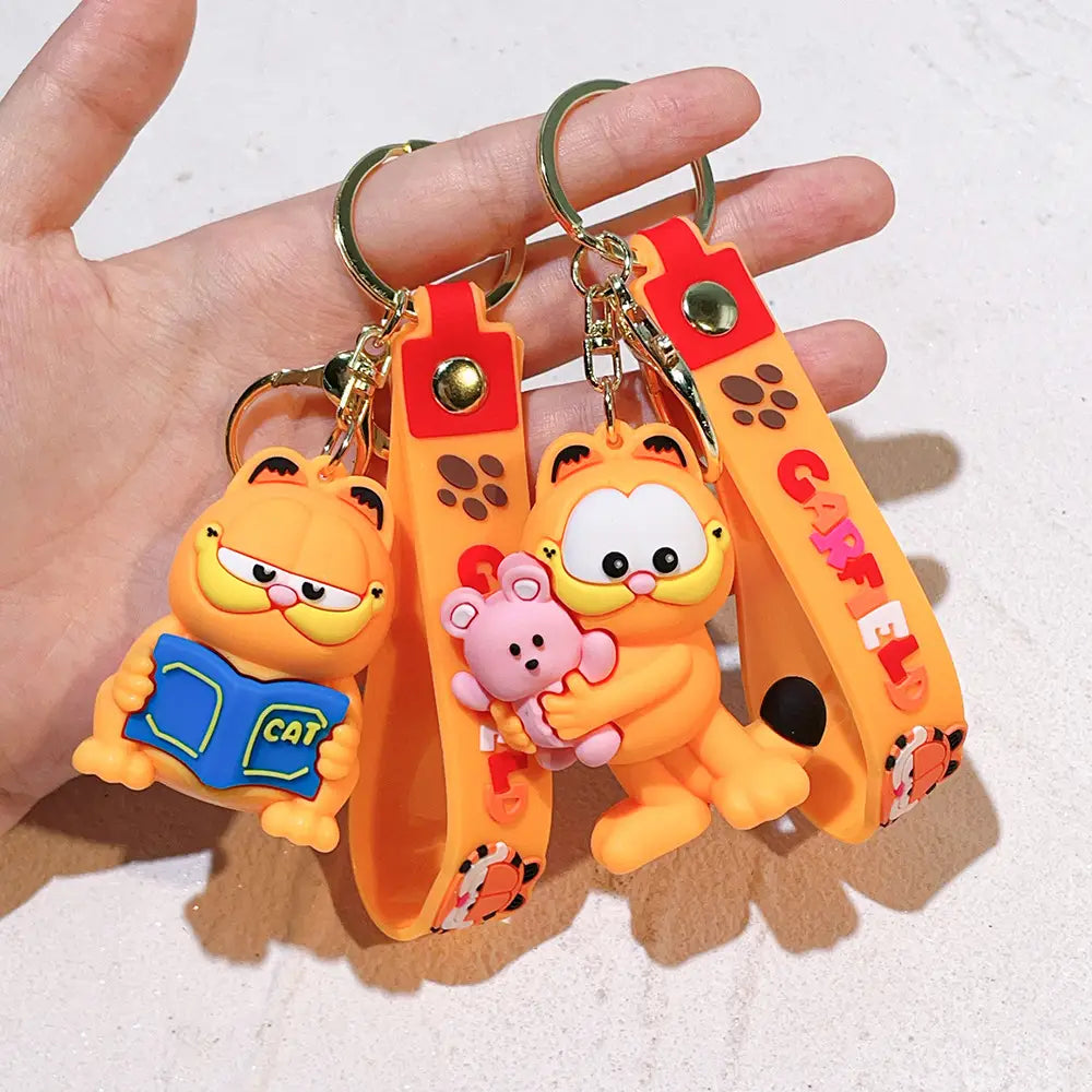 Orange garfield keychains featuring molded plastic figures with red-orange wrist straps in a rubber anime cat key pendant design.