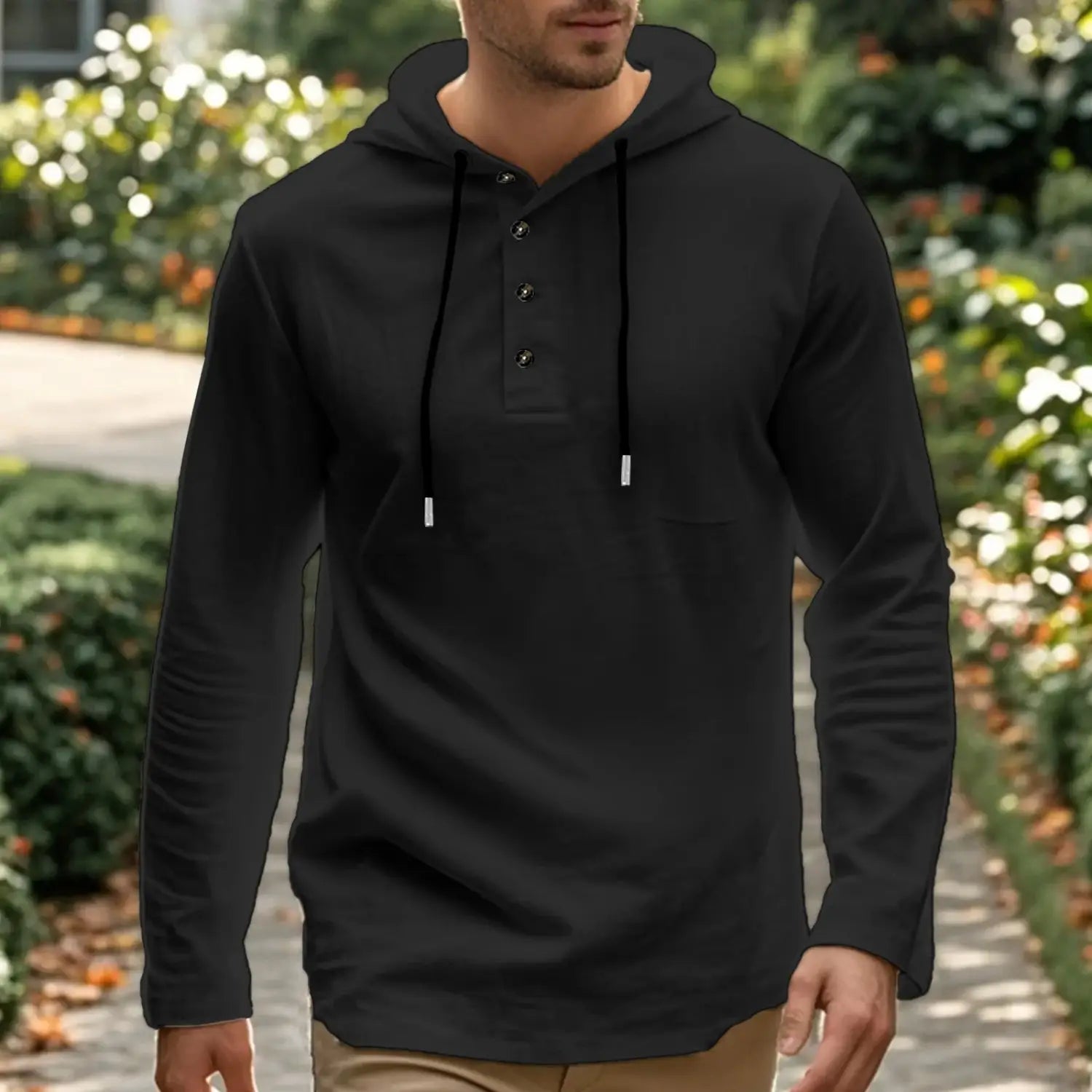 Black men cotton linen long-sleeved hooded henley shirt with front henley-style buttons and matching drawstrings.