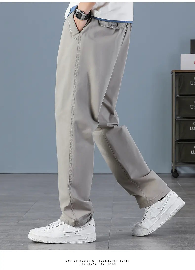 Men cargo pants cotton relaxed fit utility trousers in beige with visible stitching and a casual straight-leg chino style.