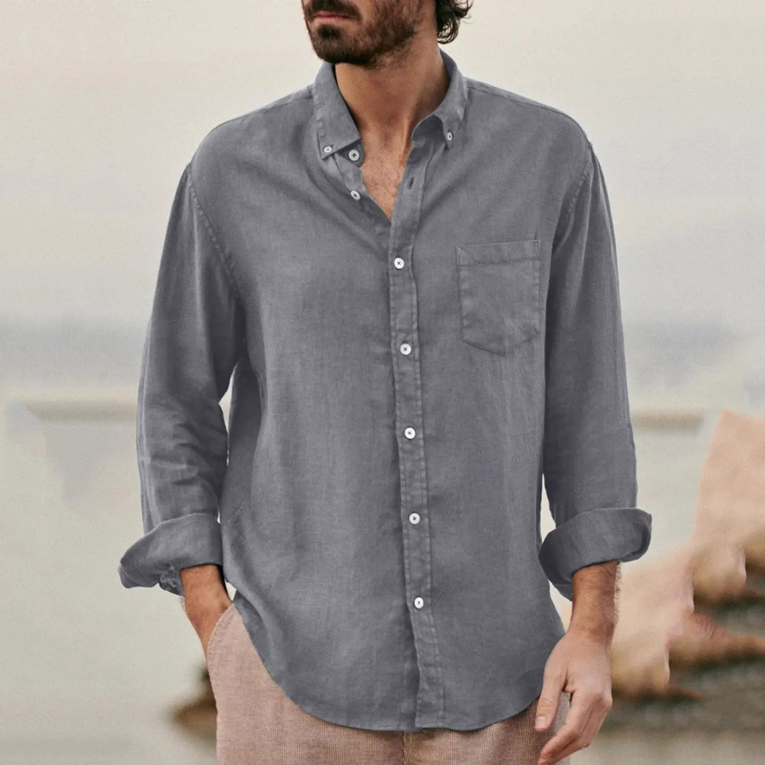 A men linen blend casual shirt in gray linen with a button-down front, rolled-up sleeves, and a chest pocket.