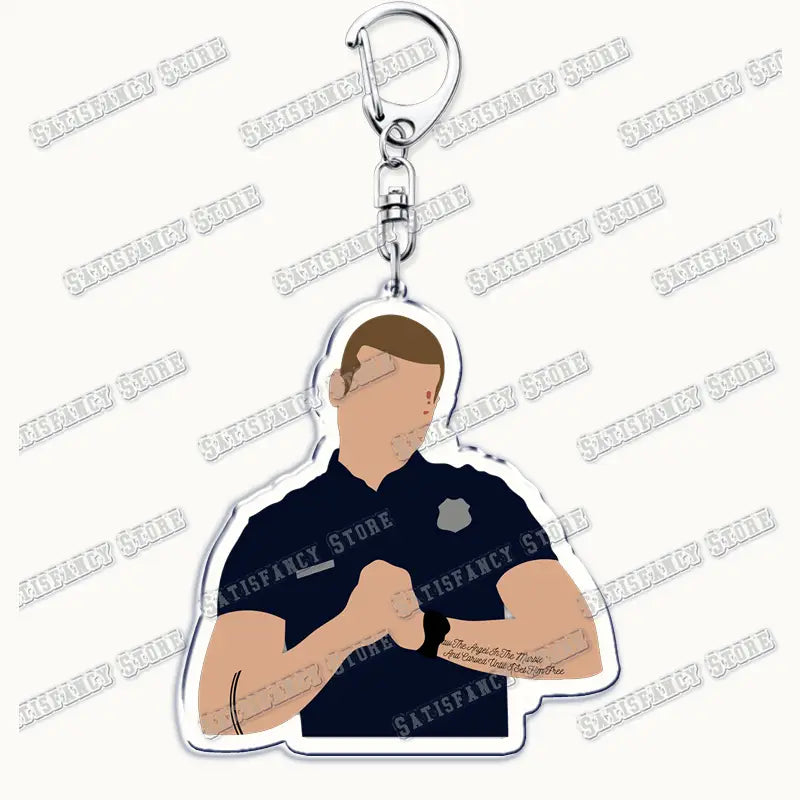 A clear acrylic 9-1-1 TV show keychain featuring a stylized illustration of a police officer in a navy blue uniform with a silver badge, brown hair, and visible arm tattoos, ideal as a firefighter gift.