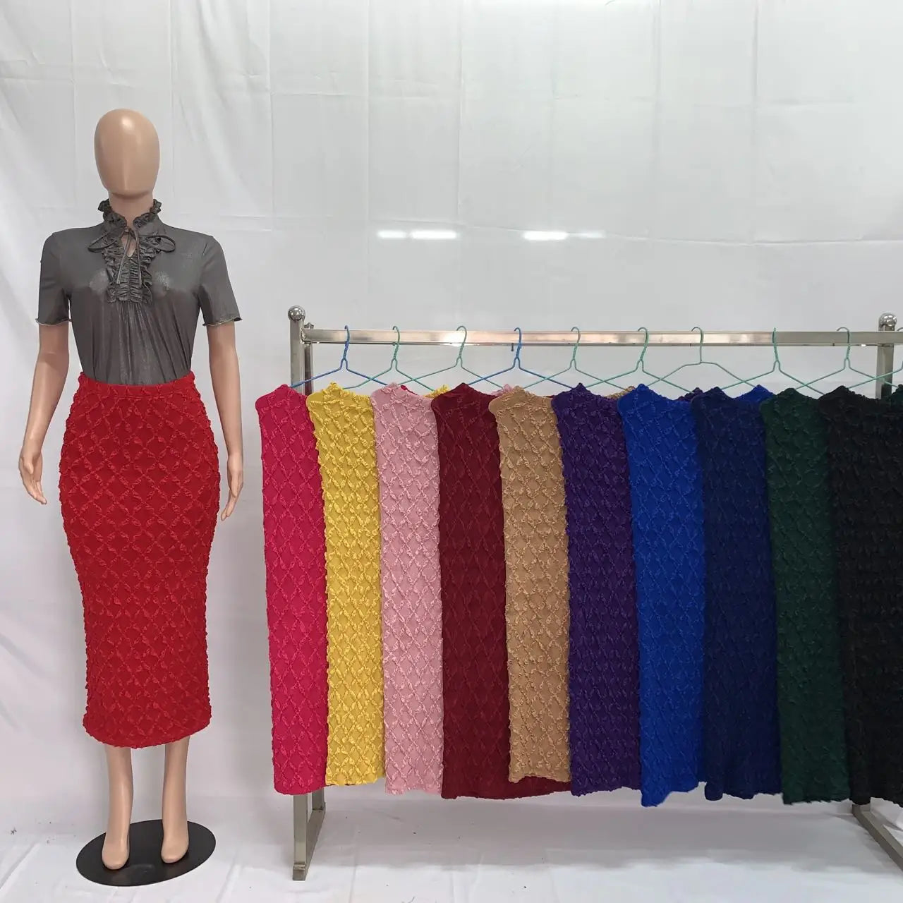 high waist slim fit knit midi skirt in red textured fabric displayed on a mannequin