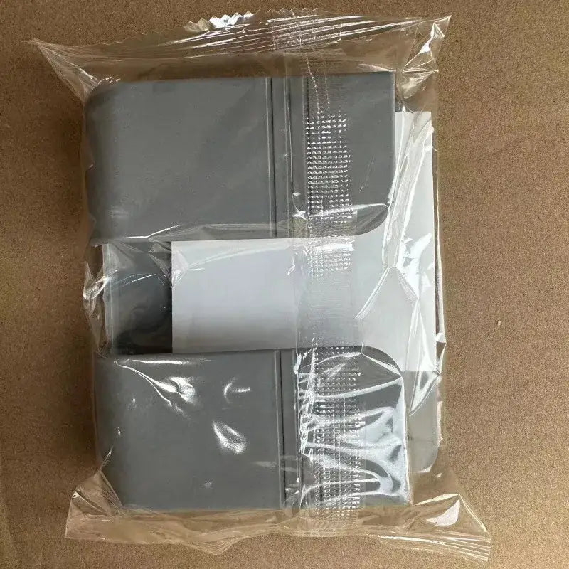 gray plastic electrical junction box cover with a textured surface and integrated mounting clips shown on the back side of a wall mount phone charging holder white.