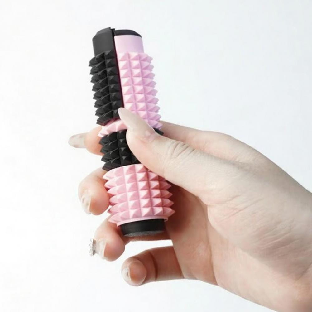 Rodillo giratorio para fidget con pinchos rosa y negro con textura, con superficie de silicona, diseñado como juguete antiestrés tipo fidget 5 en 1