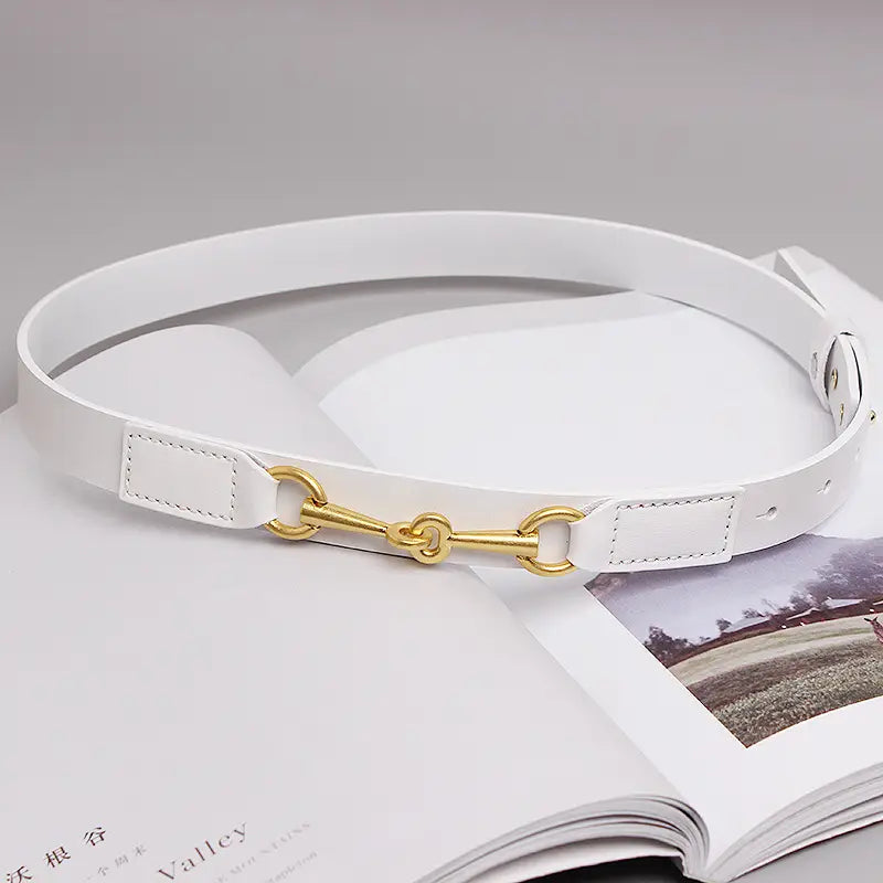 White leather belt for women featuring a gold-tone horsebit buckle.