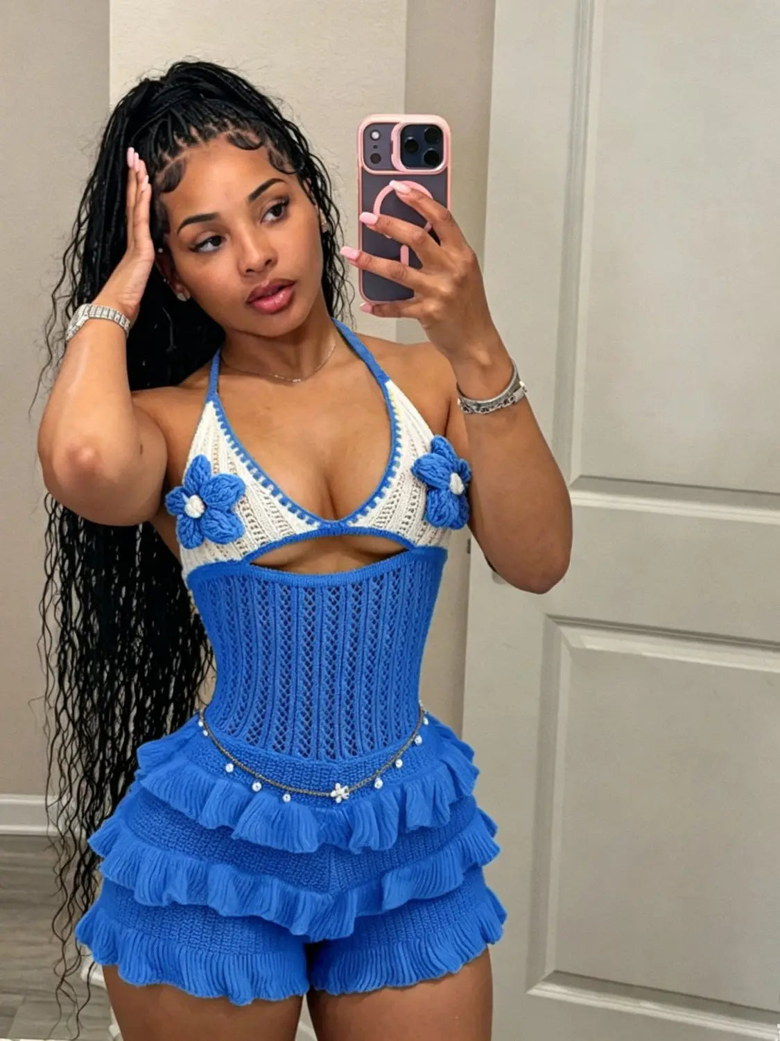 Knitted ruffle halter romper summer playsuit featuring a blue and white crocheted halter top with floral embellishments and matching ruffled shorts.