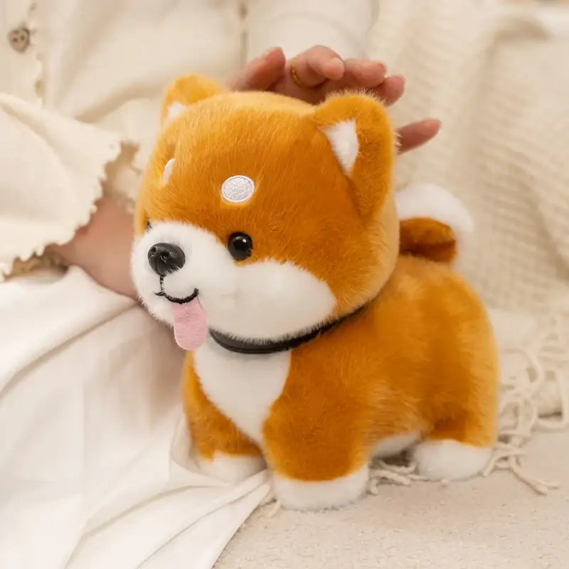 A plush orange and white shiba inu dog stuffed animal toy featuring a black collar, pink tongue out, and a silver coin-shaped patch on its forehead.