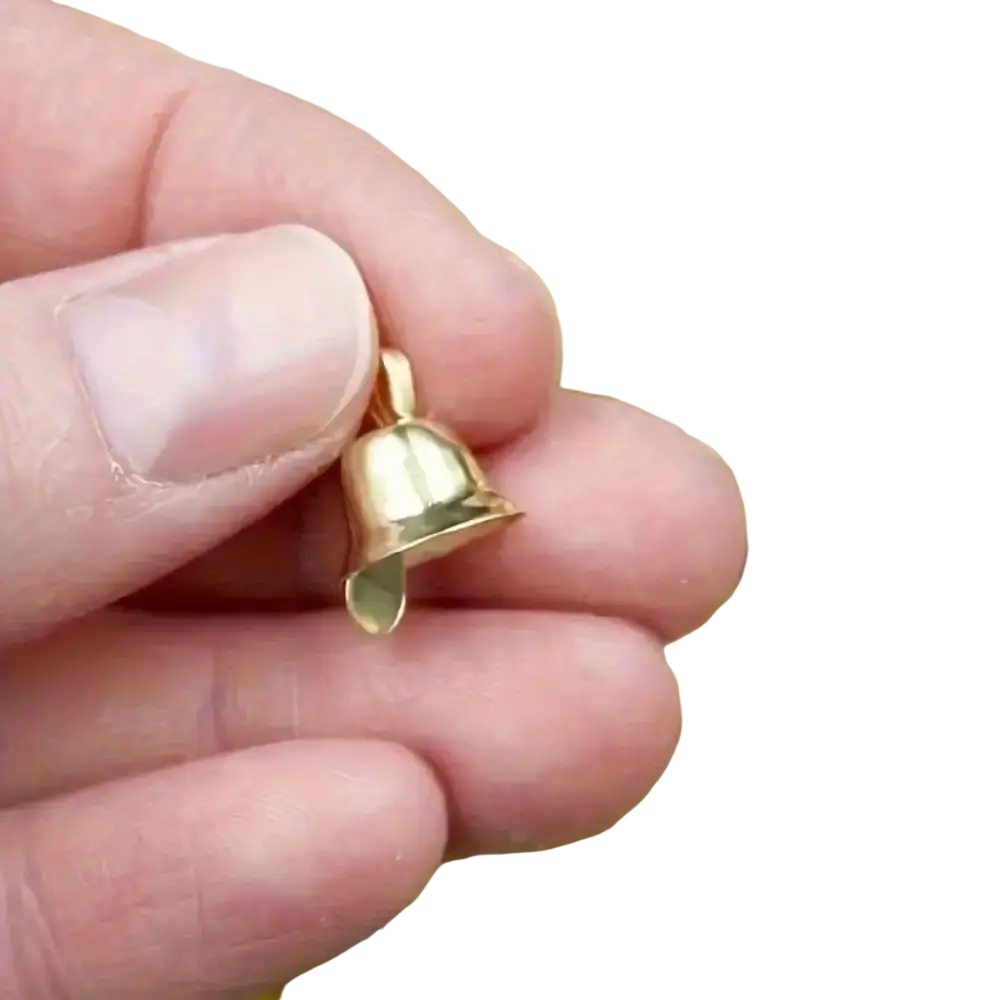A small shiny gold metal bell pendant with a smooth finish and attachment loop for diy christmas decorations