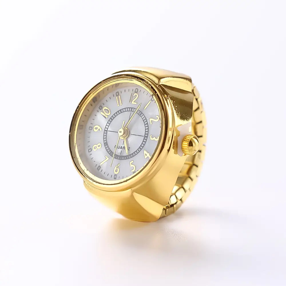 Gold-toned ring watch quartz finger jewelry unisex gift with a round face, white dial featuring black arabic numerals, gold hands, and a textured metal band.