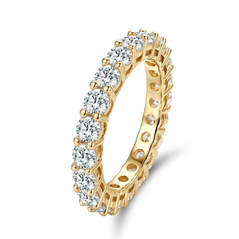 A gold eternity band ring adorned with a continuous row of sparkling round cut diamonds shown as a sterling silver zircon ring for women.