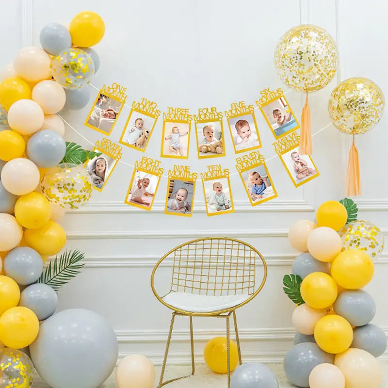 yellow photo banner with gold lettering displaying baby milestone photos for 1st birthday photo banner monthly picture garland decoration.