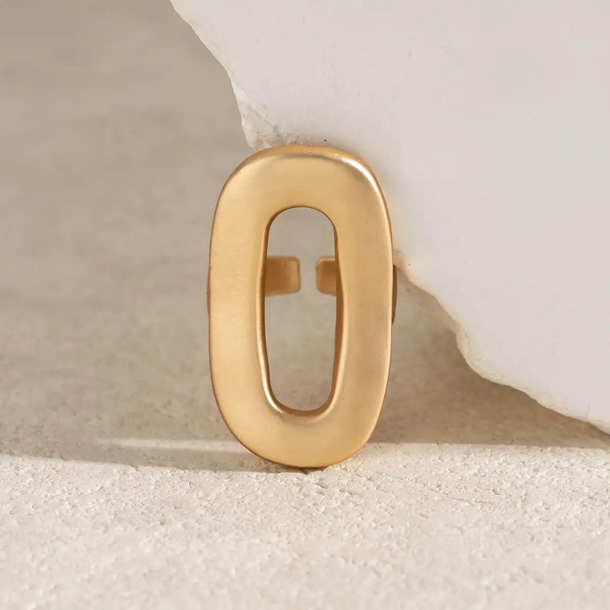 Gold-toned geometric oval open ring for women with a smooth polished finish and an open center.