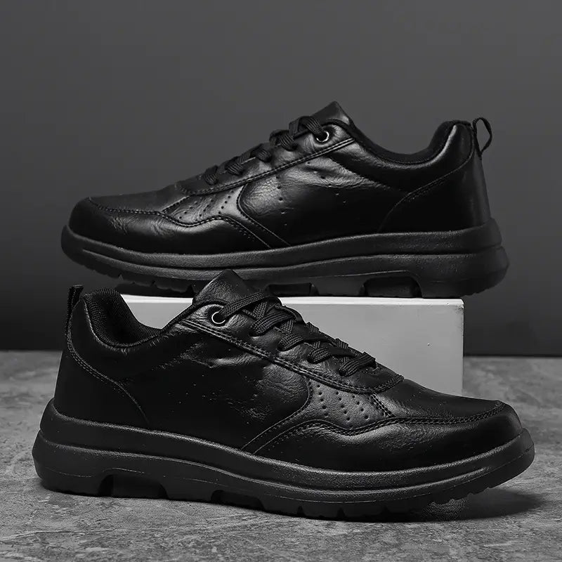 Men black leather chunky sole sneakers featuring a sleek minimalist design and sturdy rubber soles.
