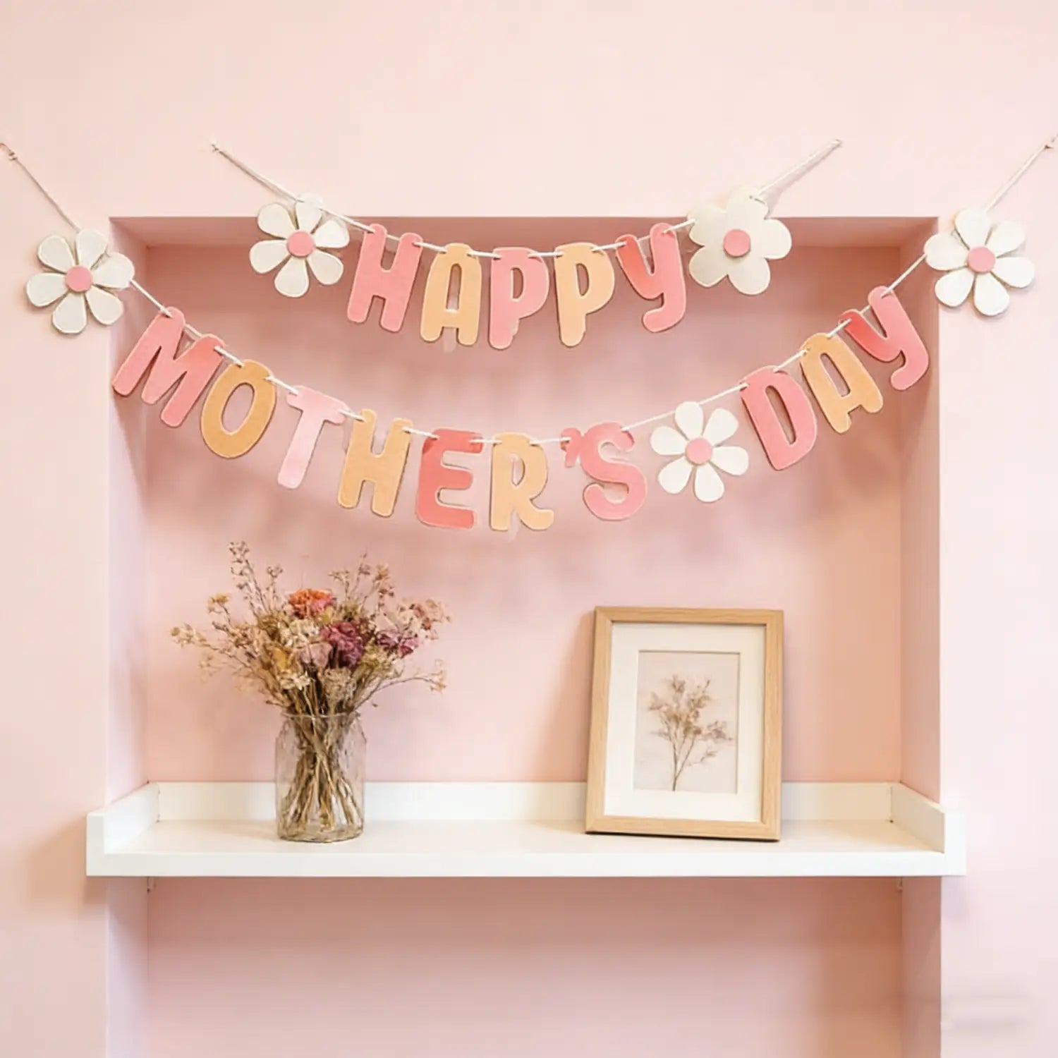 Pastel pink and white paper cutout Mothers Day Daisy paper banner wall decor with floral decorations.