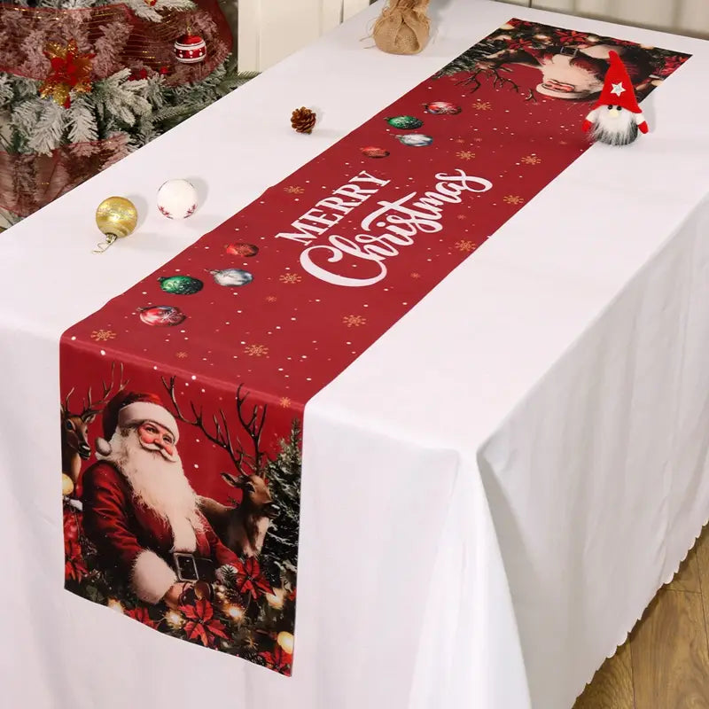 Roter Weihnachts-Tischläufer mit einem bedruckten Vintage-Weihnachtsmann mit Rentieren und festlichen Ornamenten im rustikalen Landhausstil sowie „Merry Christmas“ in weißer, geschwungener Kalligrafie