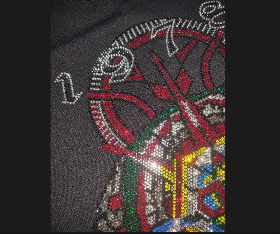 A dark gray men rhinestone devil bear graphic tee featuring a vibrant rhinestone-embellished stylized skull with red, green, and silver accents.