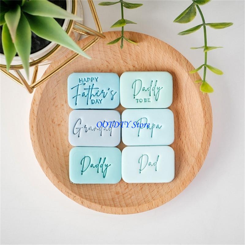 Set of six light blue silicone father’s day cookie cutter and fondant stamps engraved with affectionate messages such as happy father day and daddy to be.