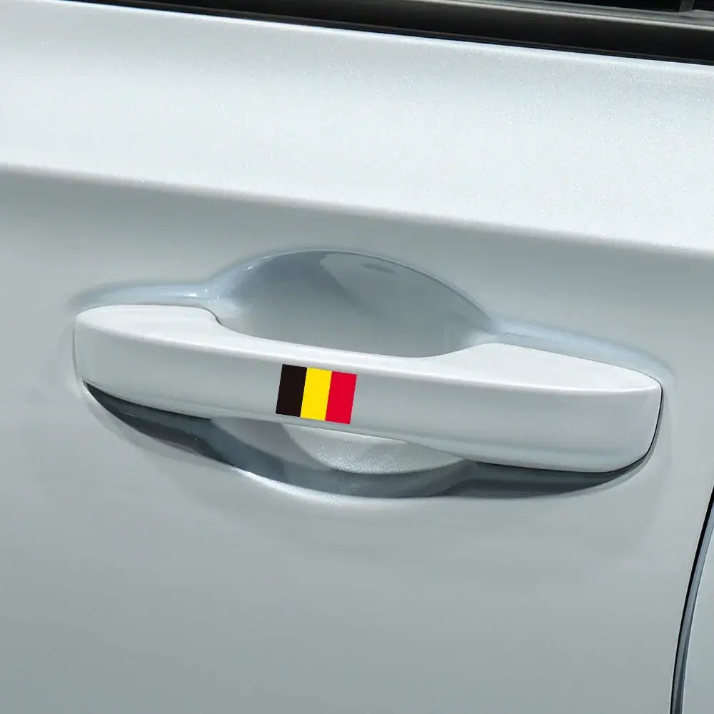 White car door handle with a small waterproof Belgian flag PVC sticker affixed to its center for car decoration.