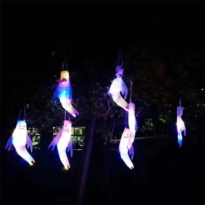 illuminated colorful fish-shaped halloween ghost led hanging windsocks for home outdoor display hanging from branches against a dark night sky