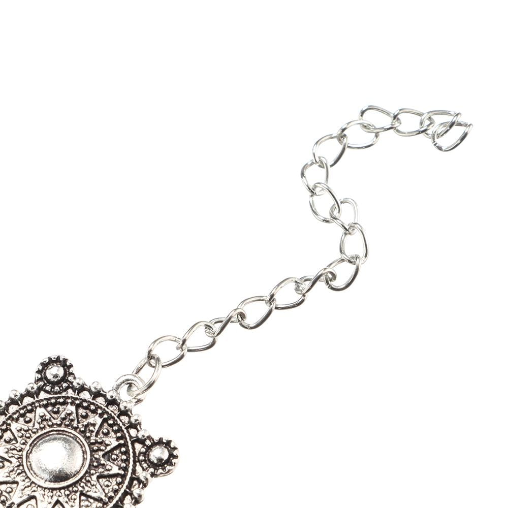 Boho silver vintage jewelry set featuring a silver-toned ornate pendant with intricate filigree design and a central circular embellishment on a delicate chain.