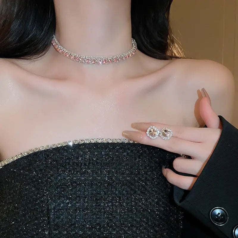A sparkling pink and clear rhinestone choker necklace from the crystal necklace and earring set pink ab wedding jewelry worn around the neck.