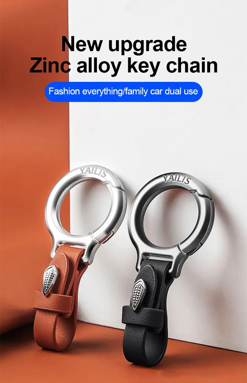 Lederschlüsselanhänger für den Pkw, mehrzweckiger Anti-Verlust-Halter aus Zinklegierung in Silberoptik, mit braunen und schwarzen Lederriemen sowie einem eleganten metallischen Ringdesign.