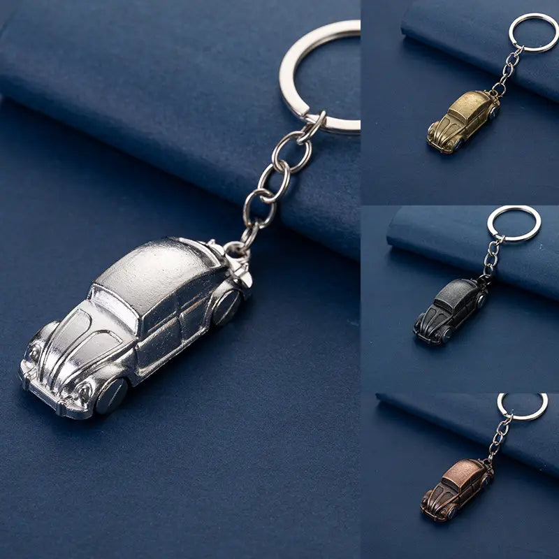 Silver metallic keychain featuring a detailed miniature Volkswagen Beetle design in metal for car enthusiasts.