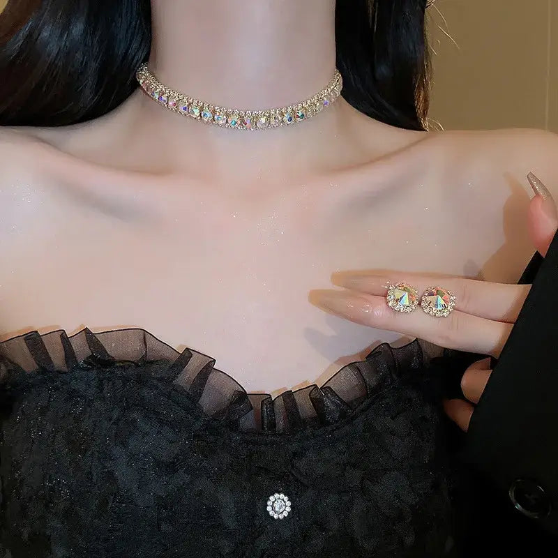A sparkling gold choker necklace adorned with a row of iridescent pink ab rhinestones from a crystal necklace and earring set for wedding jewelry.