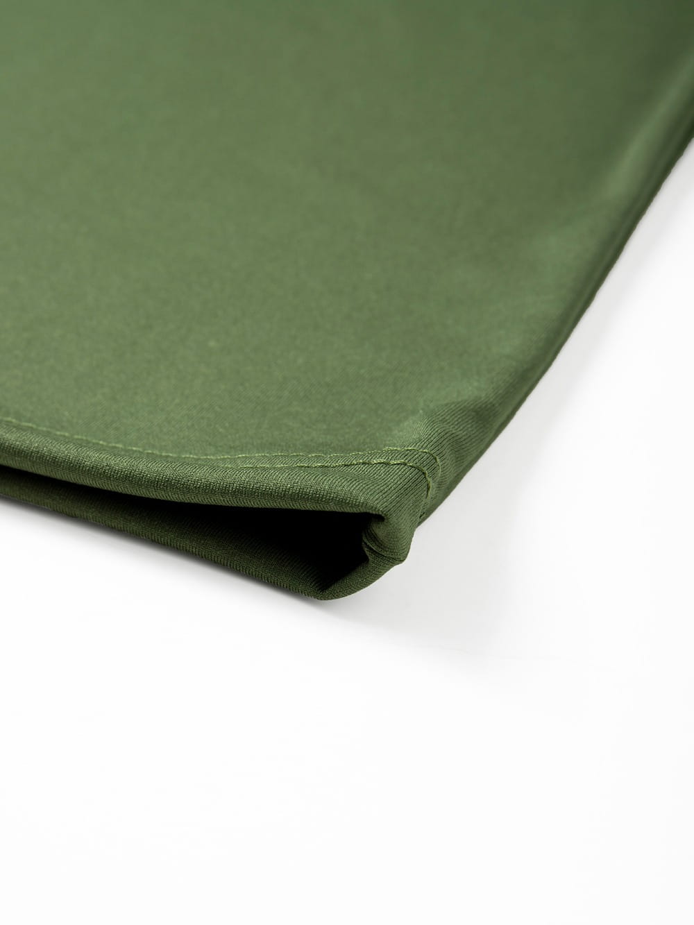 olive green canvas fabric with neatly stitched edges used in mens raglan long sleeve casual t-shirt.
